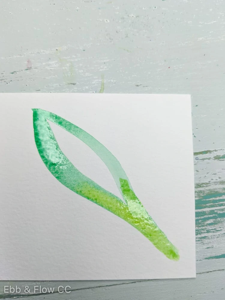 dropping yellow into wet green painting of leaf