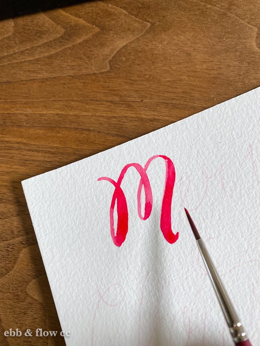hand painted letter M in red watercolor