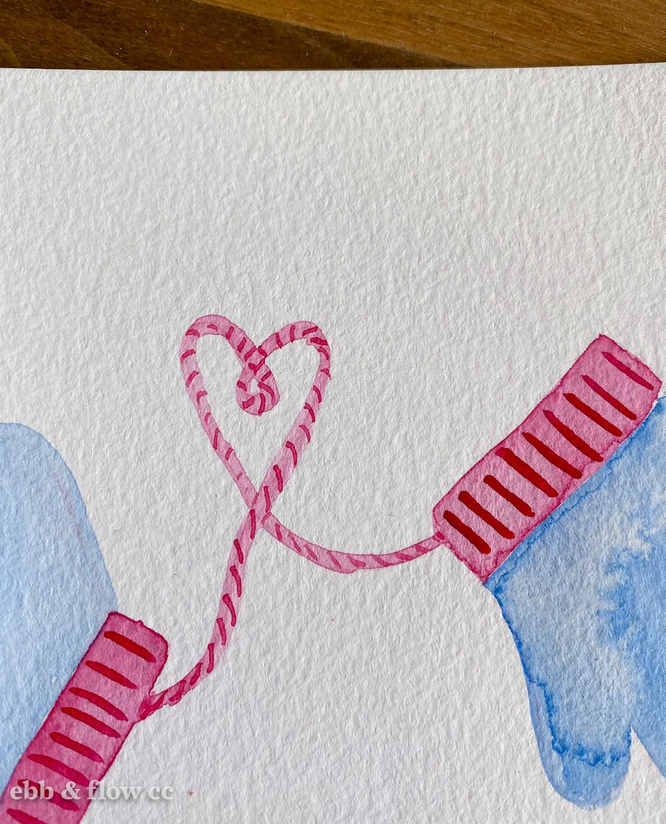 close up of heart string on mitten illustration