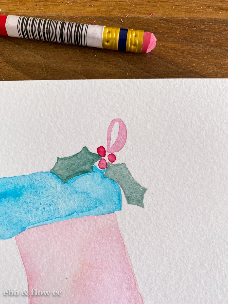 close up of holly leaves on stocking painting