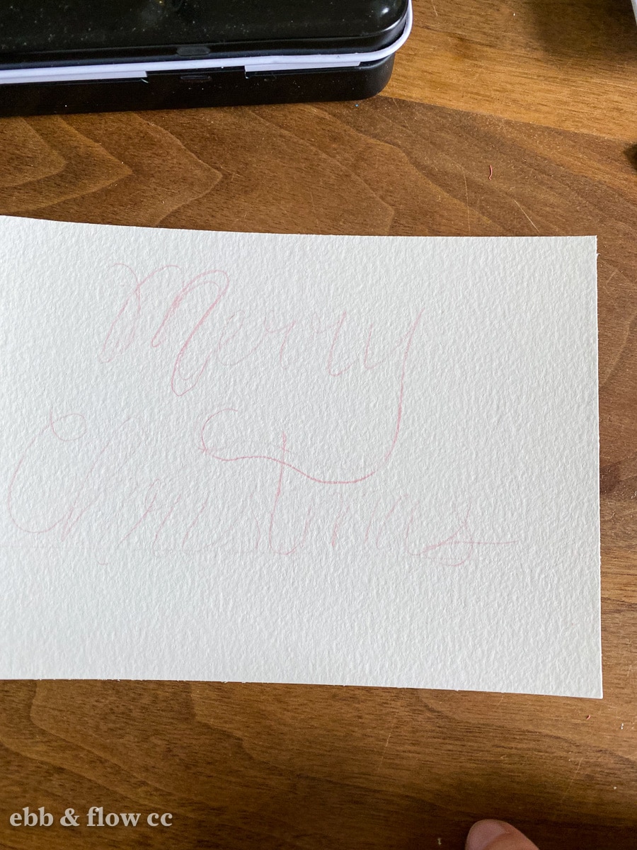paper that lightly says "Merry Christmas"