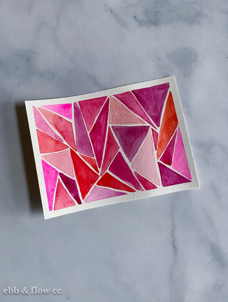triangles painted in red and pink watercolor paint