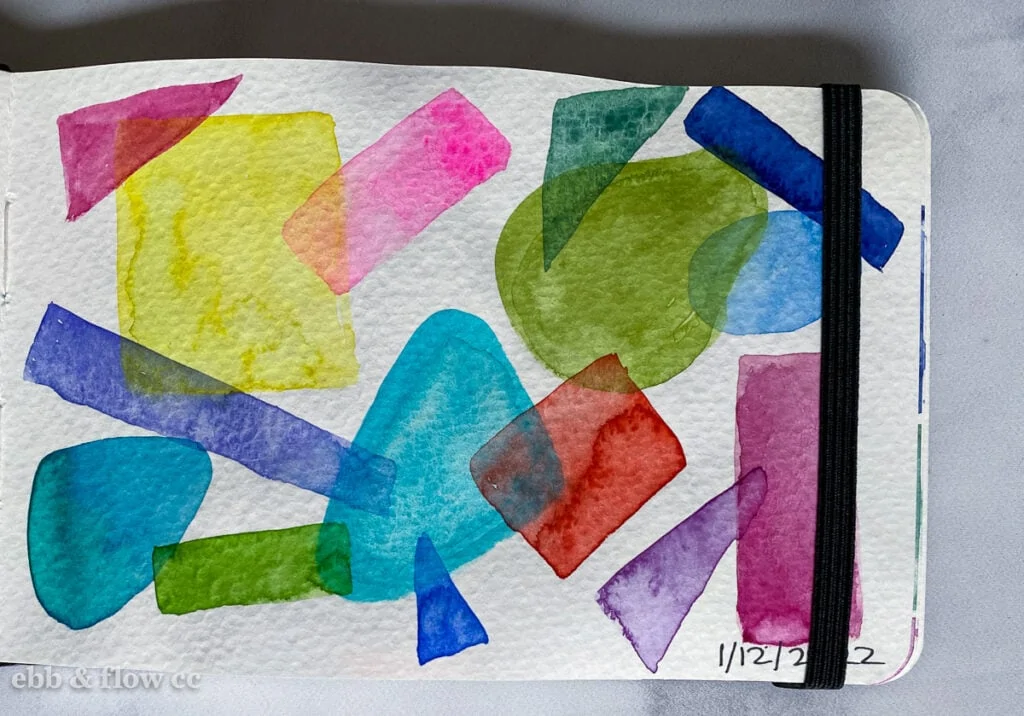 layered watercolor shapes in sketchbook