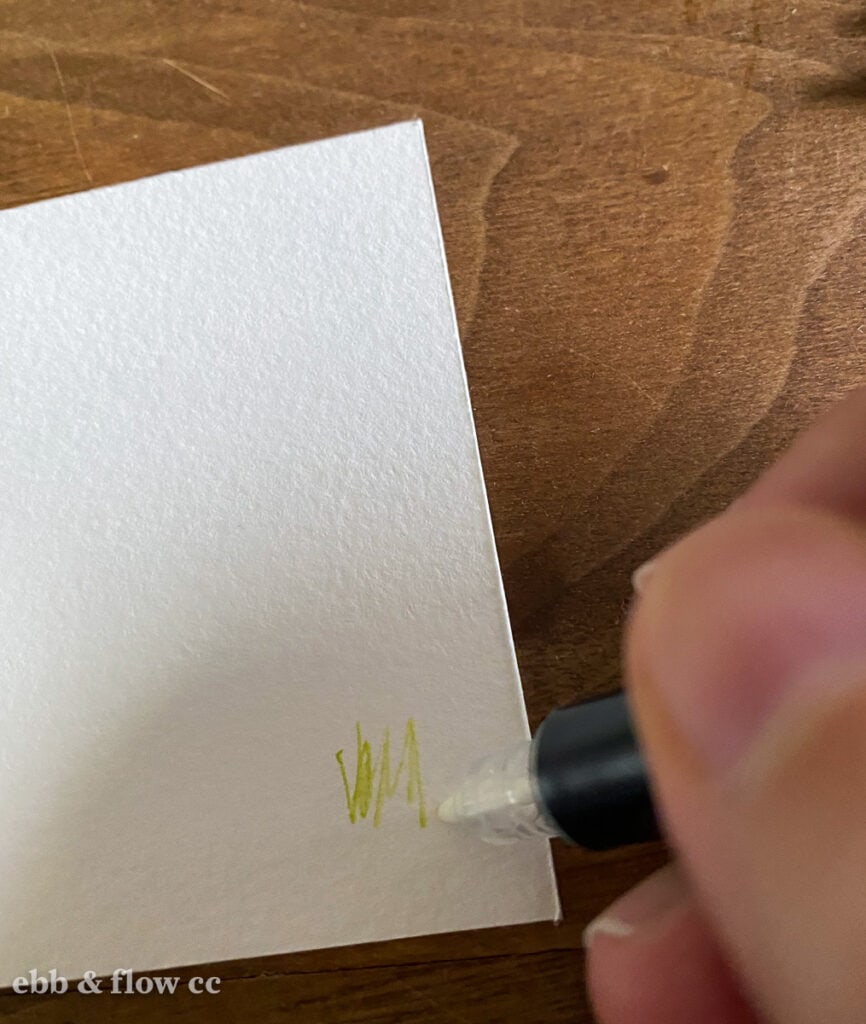 cleaning marker tip on scrap paper