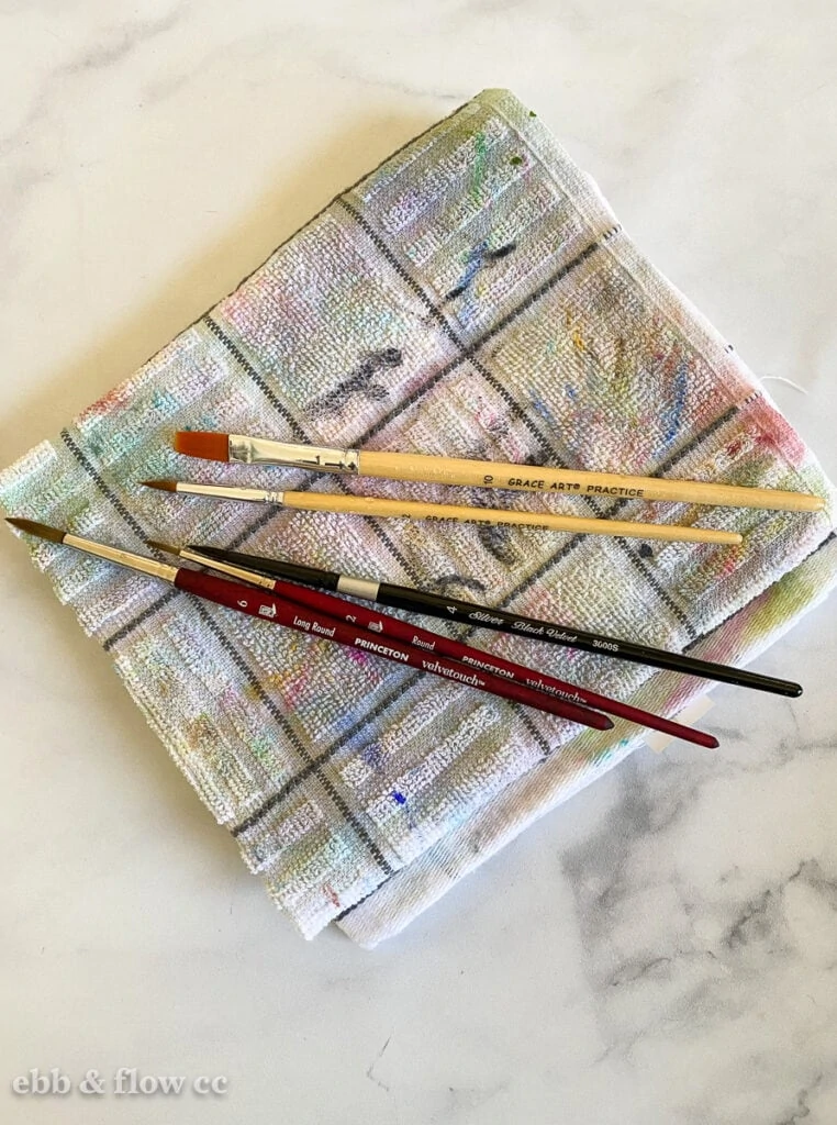 paintbrushes laying on towel to dry