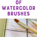 paintbrush wiping purple paint on towel