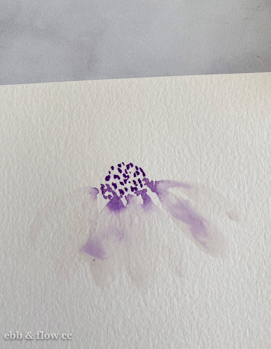 adding petals in water to watercolor flower