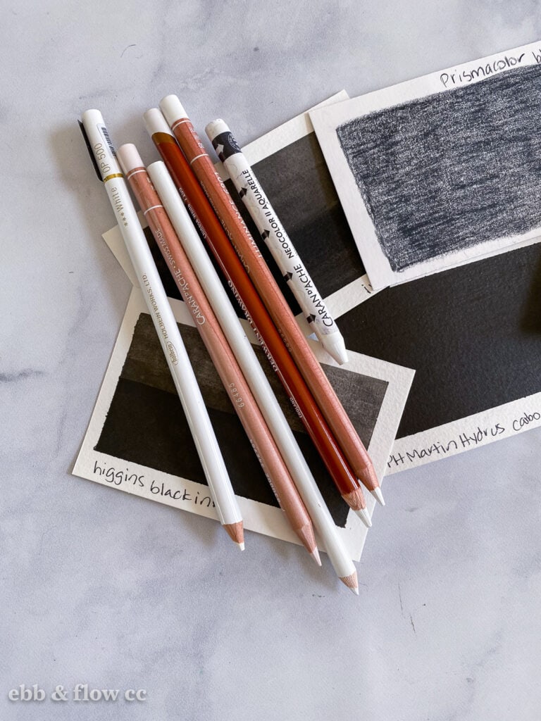 white pencils on dark swatches