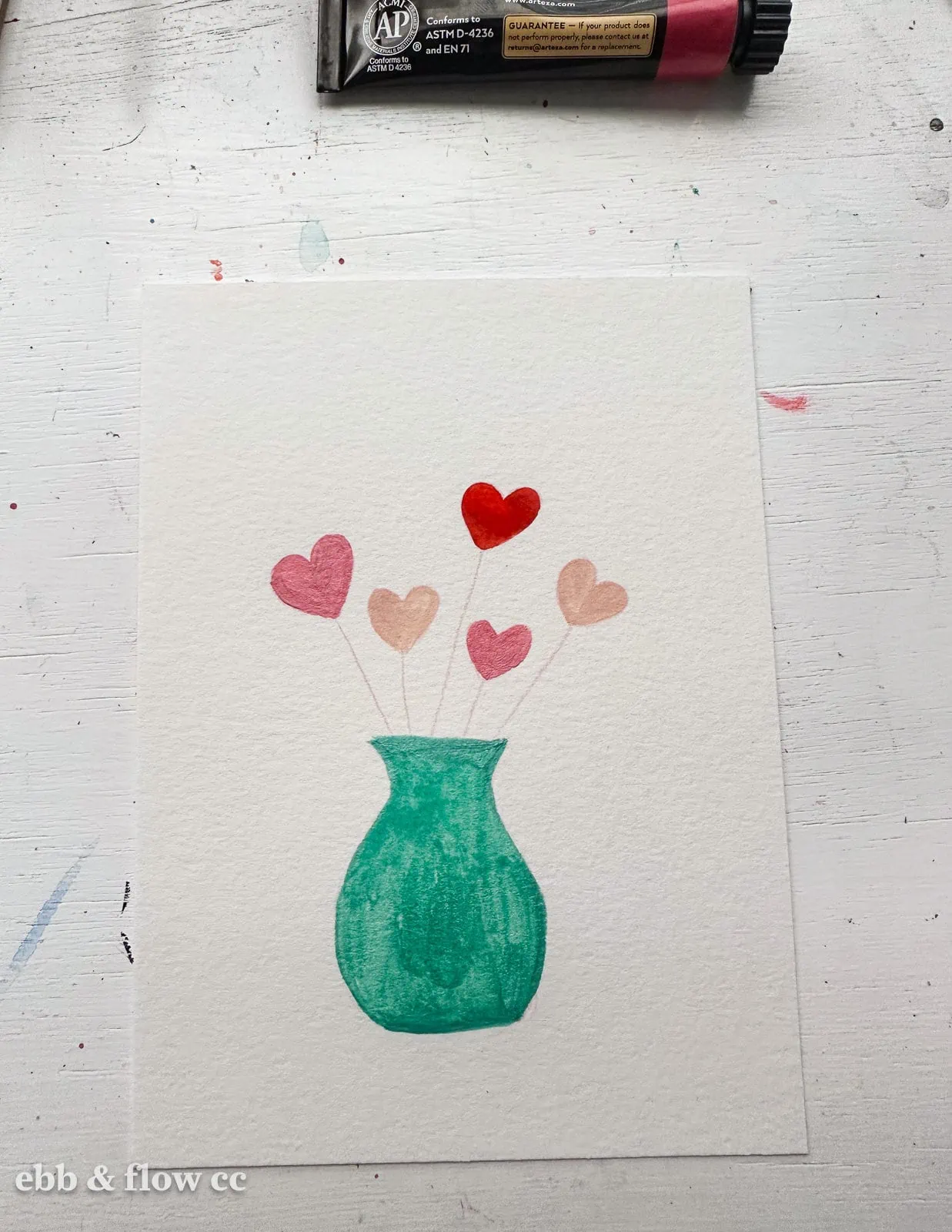green vase with pink hearts