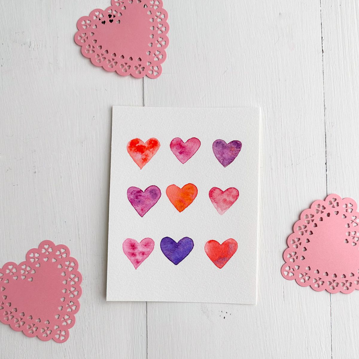 valentine card with hearts painted in watercolor paint