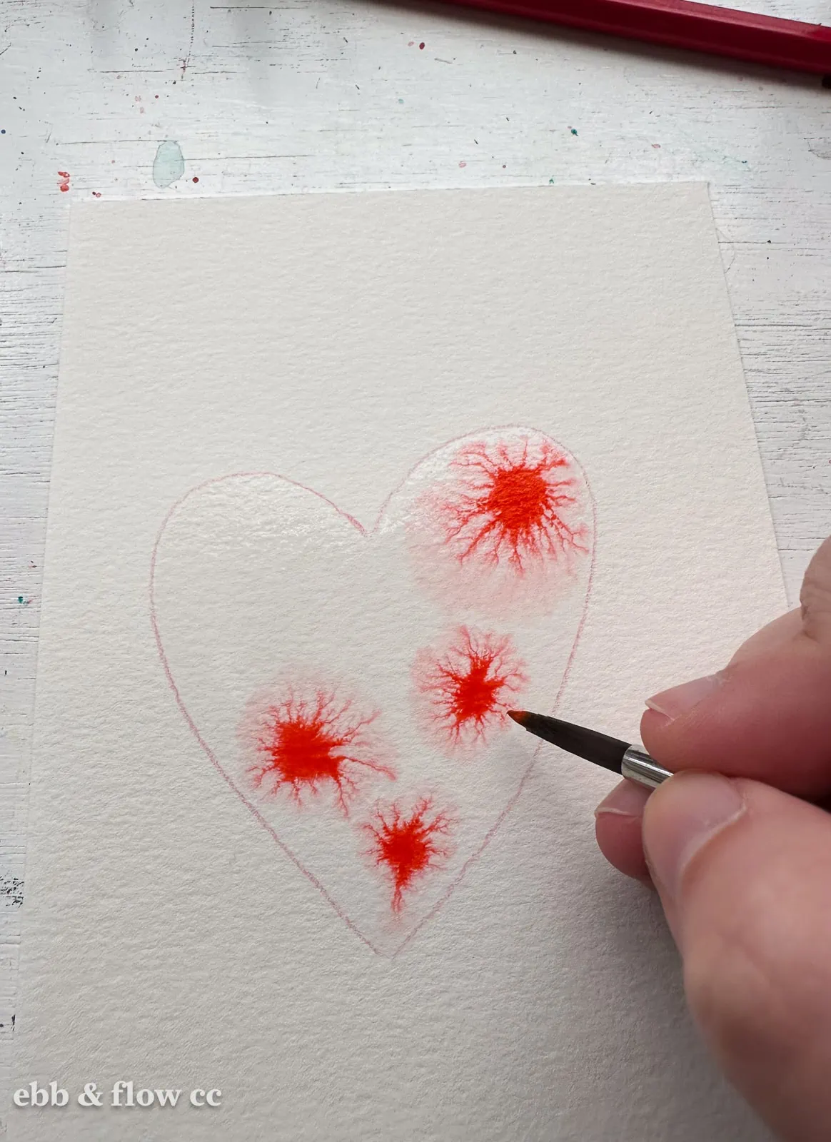 dropping paint into water shape on paper