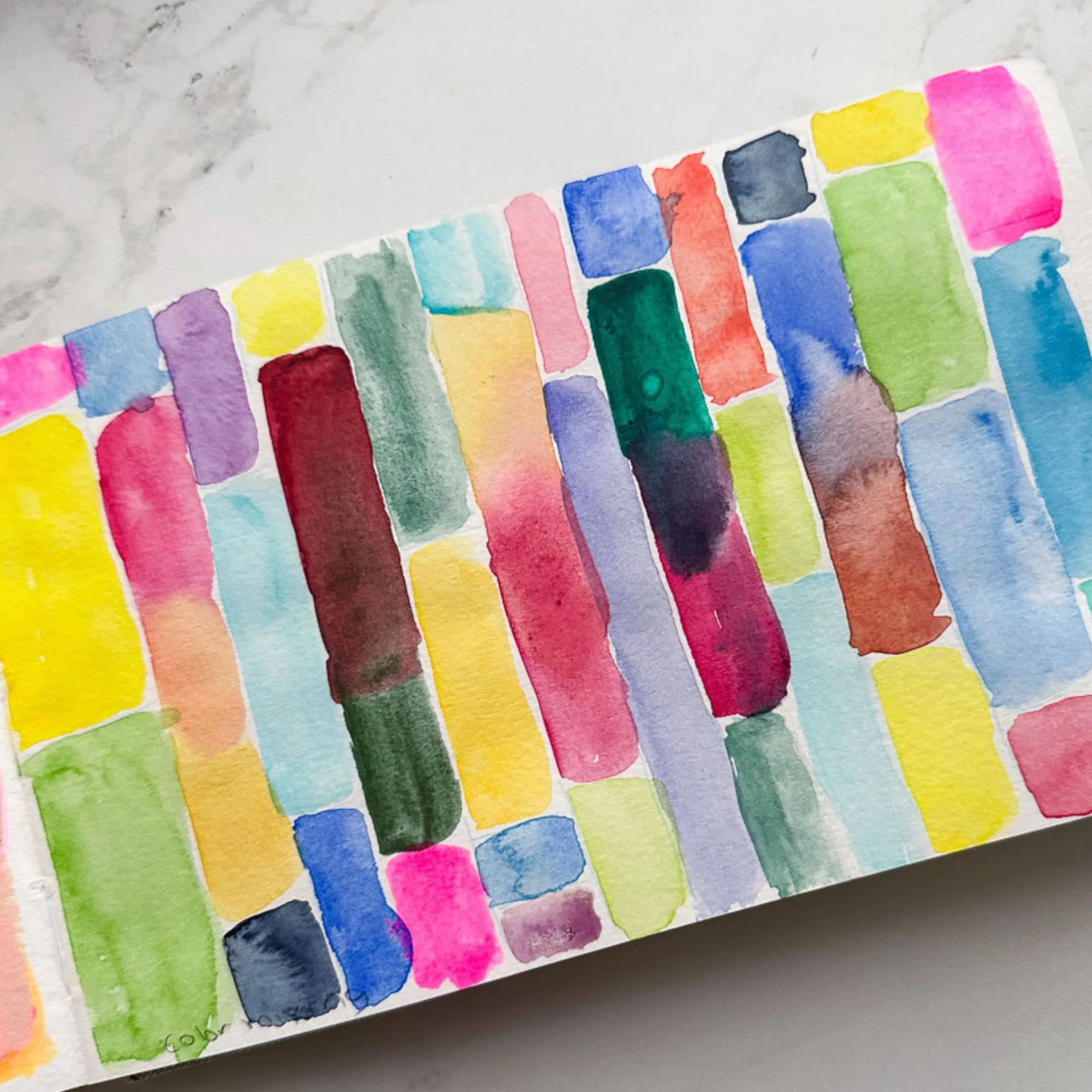 sketchbook with rectangles painted with watercolor