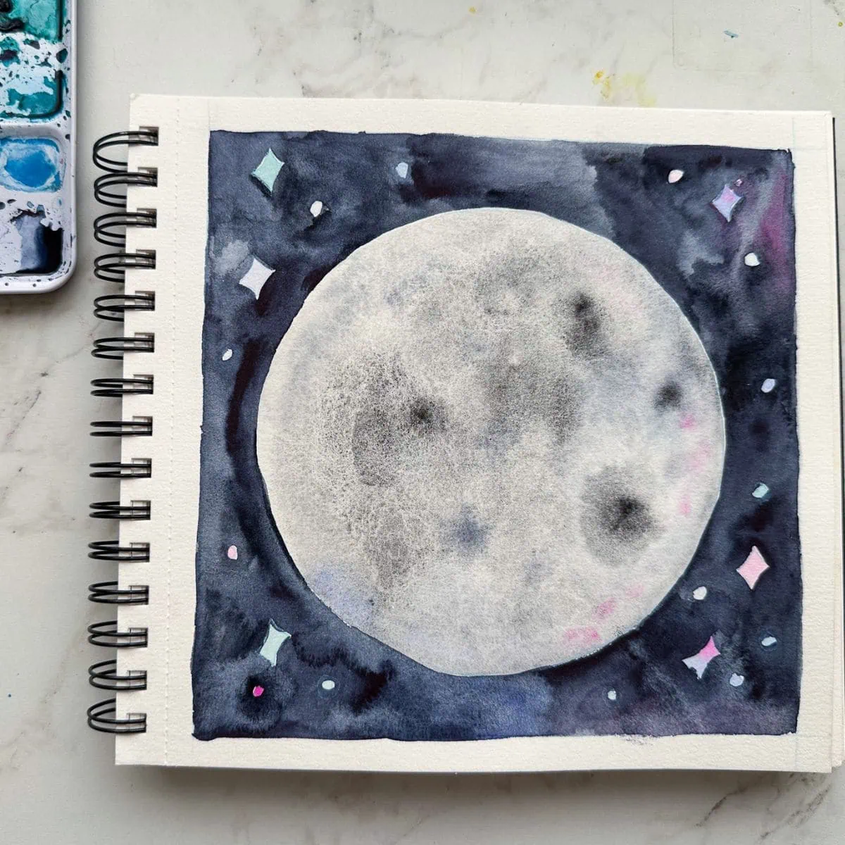 moon painted with watercolor with dark sky background