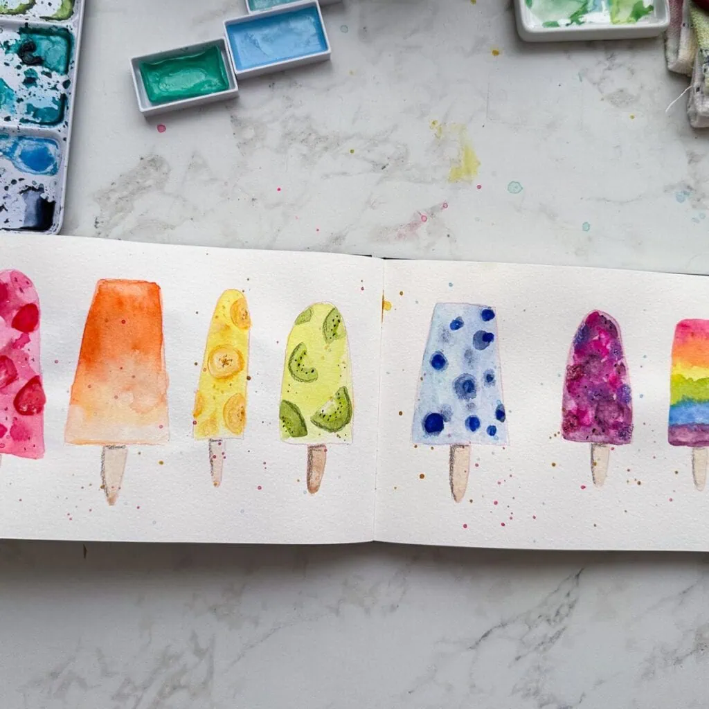 sketchbook spread of popsicles painted with watercolor