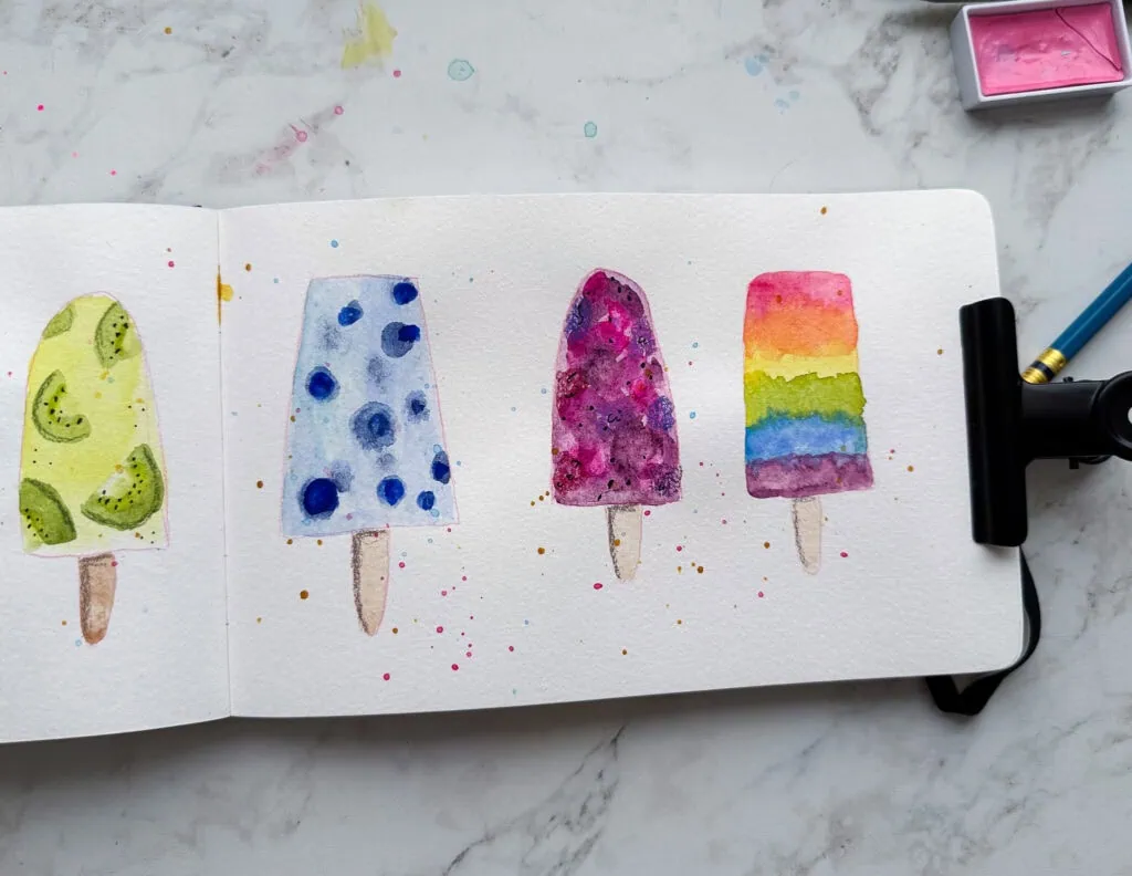 fruit popsicles painted with watercolor in a sketchbook